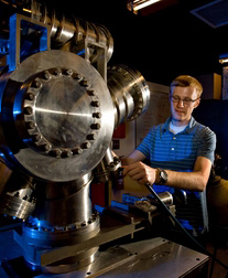 Michael Christiansen checking vacuum chamber seals for leaks.